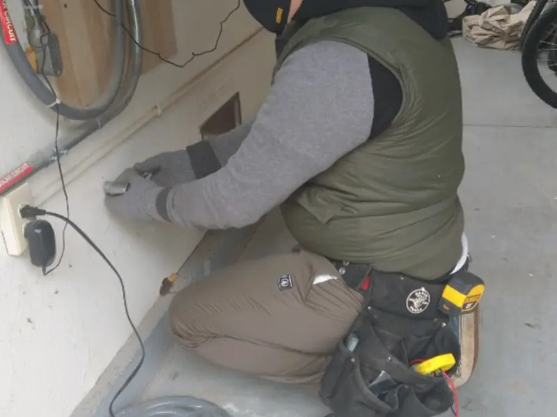 Electrician performing outlet wiring in a Sleepy Eye garage